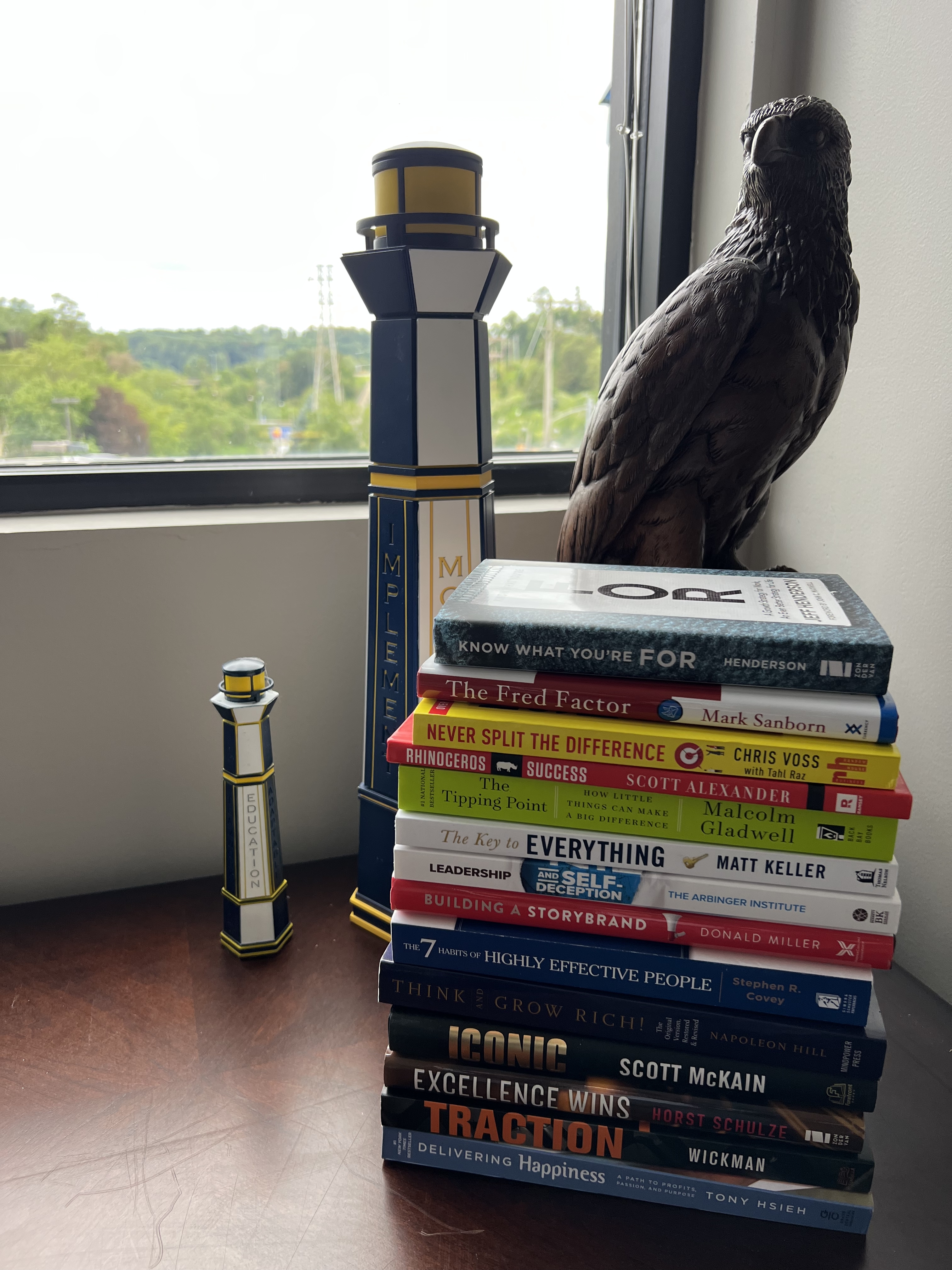 Stack of books next to a window